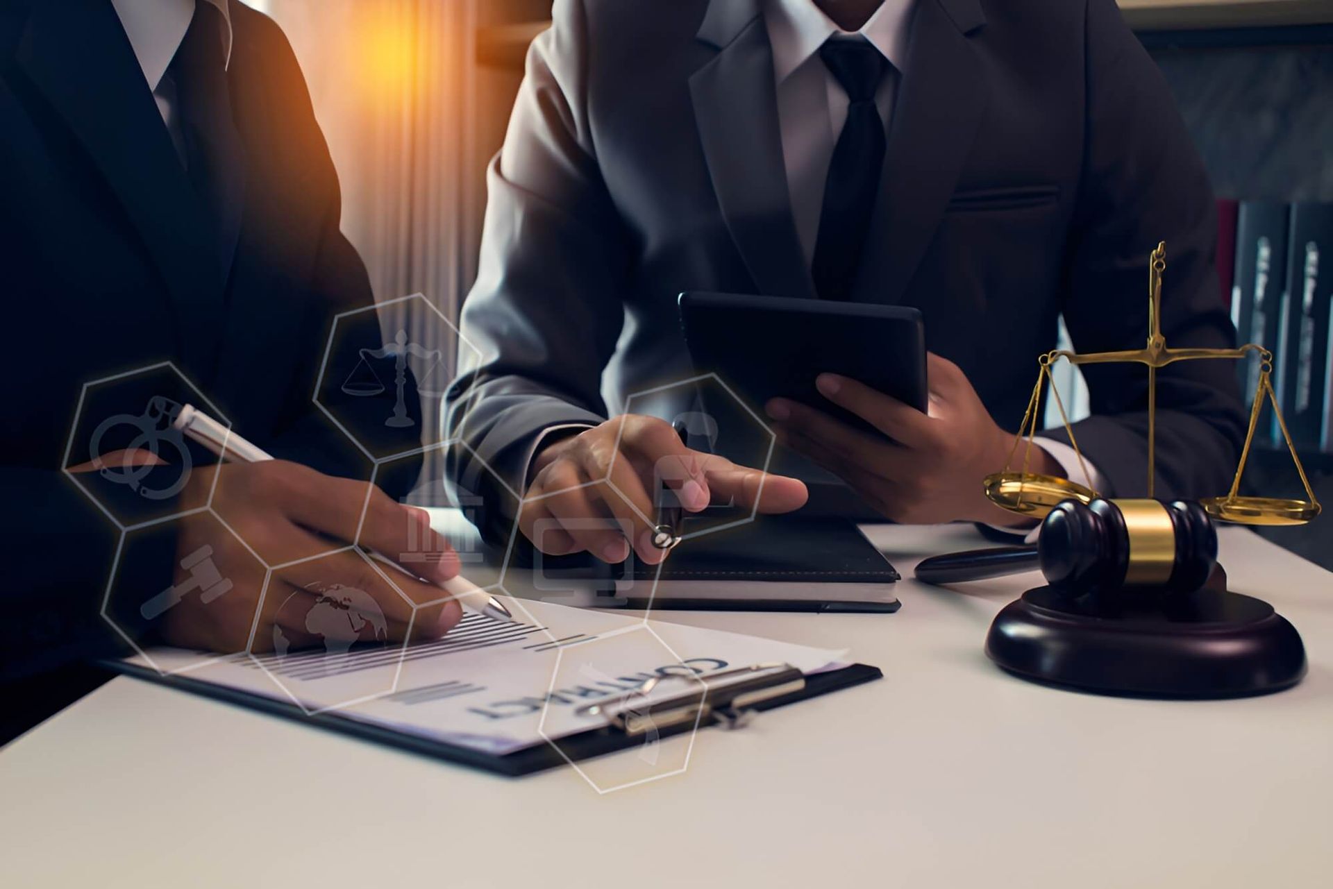 A Man and a Woman are Sitting at a Table Looking at a Tablet — Morris Legal & Conveyancing in Forster, NSW