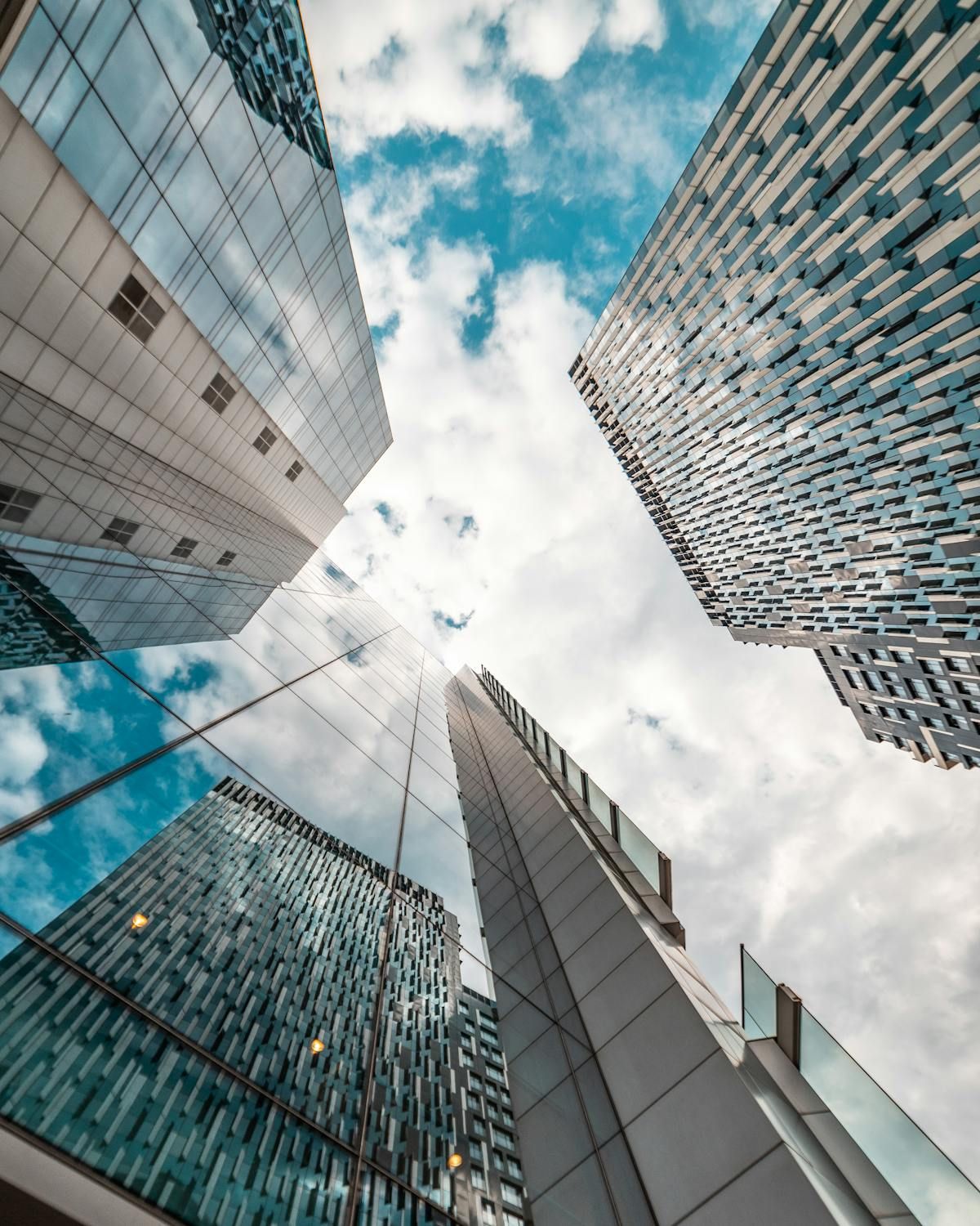 Looking up at tall buildings with a blue sky in the background