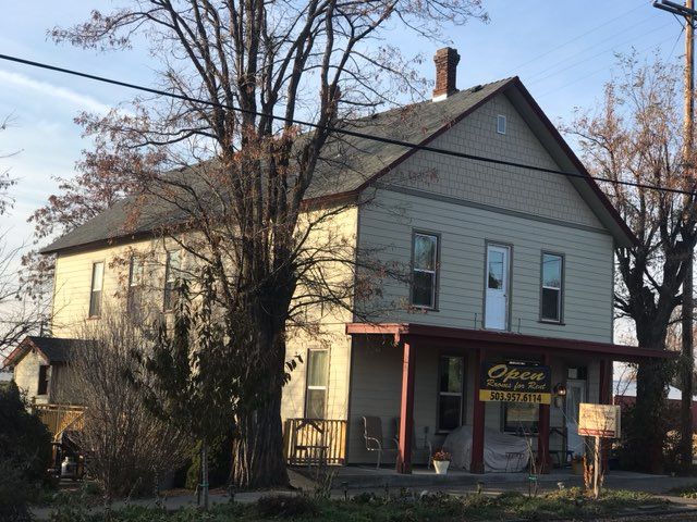 A large house with a sign that says ' open ' on it