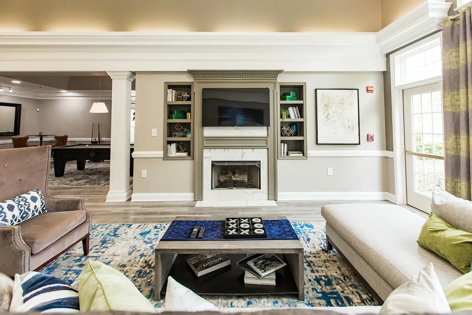 Riverscape at Piney Orchard clubhouse with TV, fire place, and sofas.