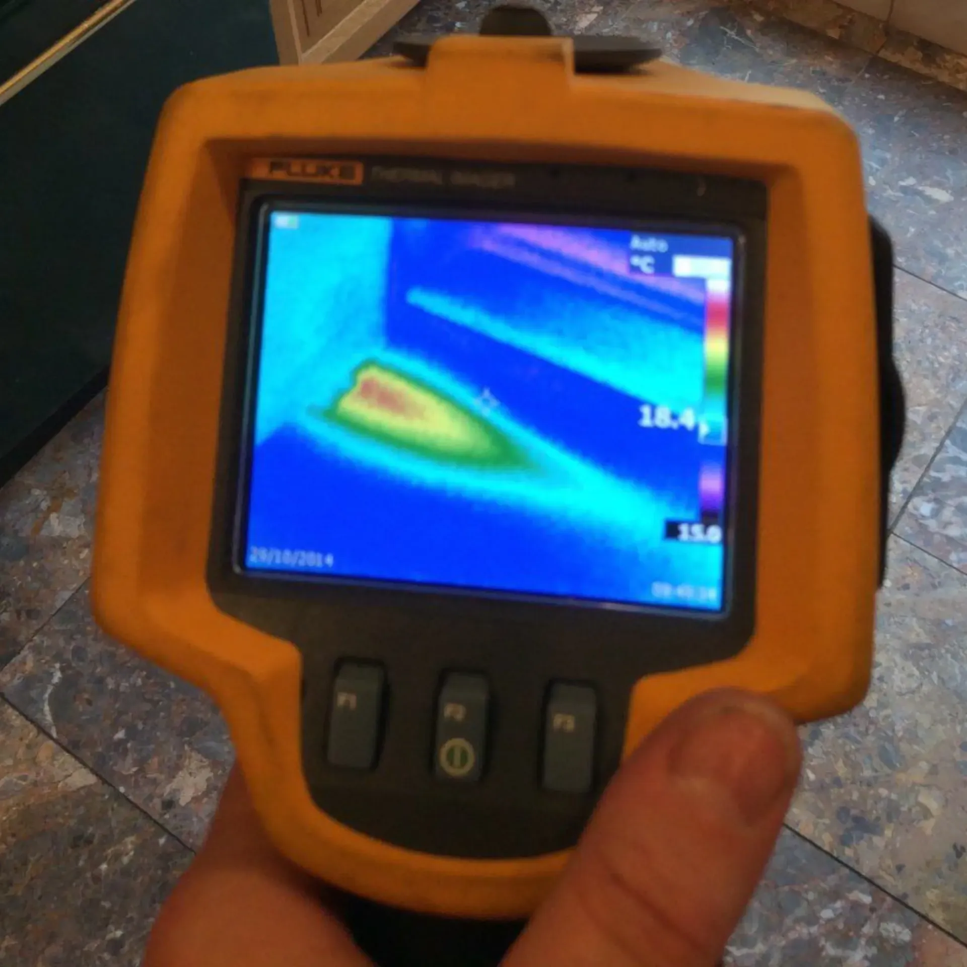 Ted & Bros Plumbing | person is holding a fluke thermal imaging device