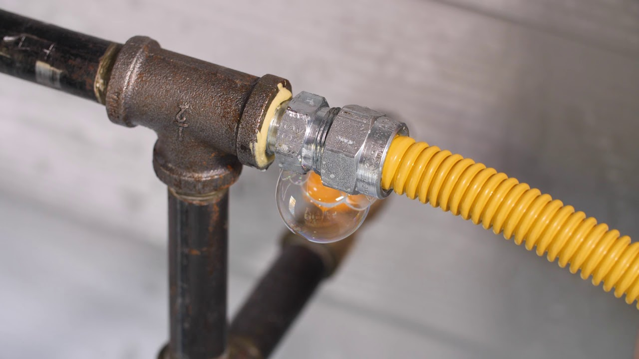 Ted & Bros Plumbing | close up of a rusty pipe with smoke coming out of it.