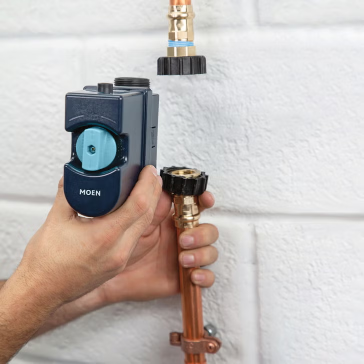 Ted & Bros Plumbing | copper pipe with a green handle is attached to a wall.
