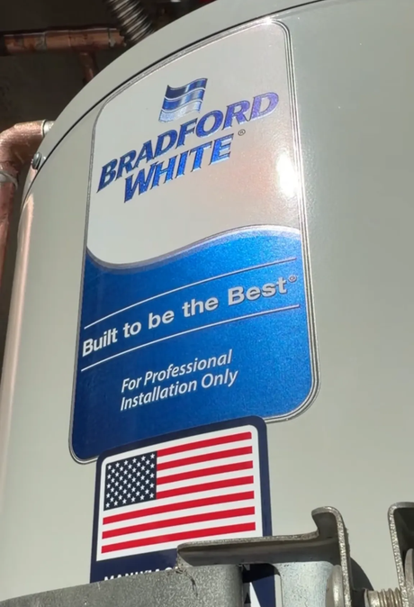 Ted & Bros Plumbing | man in a red shirt is working on a pipe