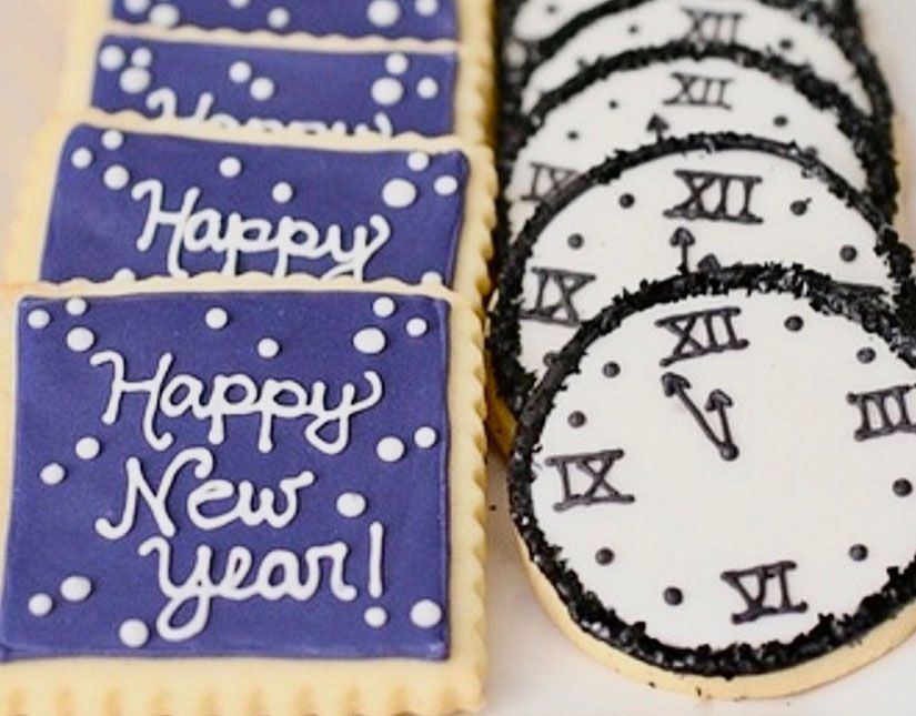 New Year cookies with purple icing and white clock designs, including “Happy New Year!” messages