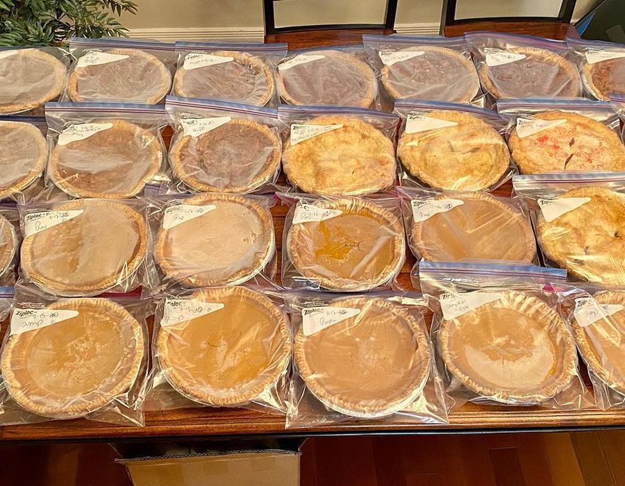 Stack of individually wrapped round pastries in clear plastic on a table