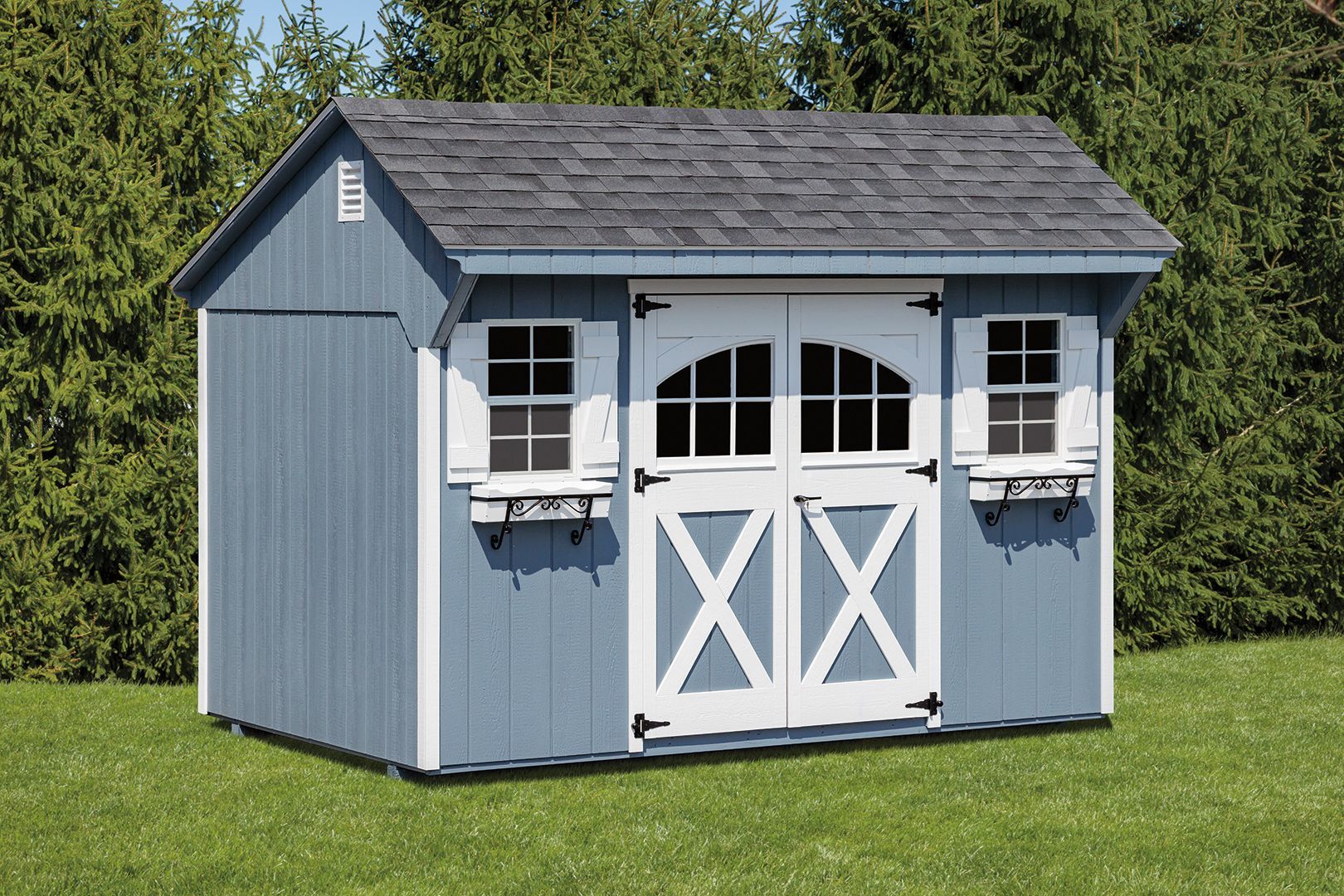 Blue shed with white trim and double doors on green grass.