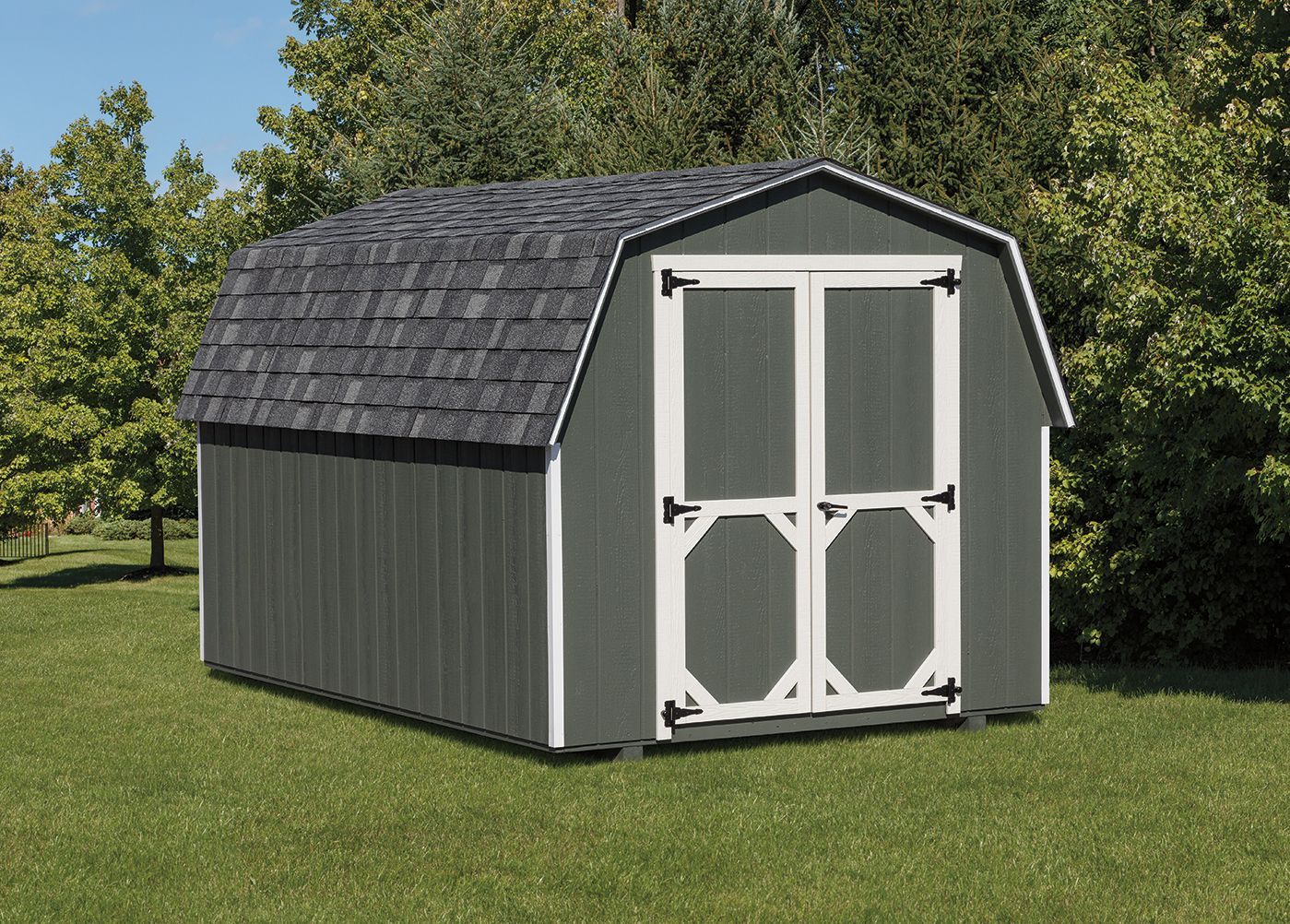 Gray barn shed with white trim, double doors, and shingled roof, set on a green lawn.