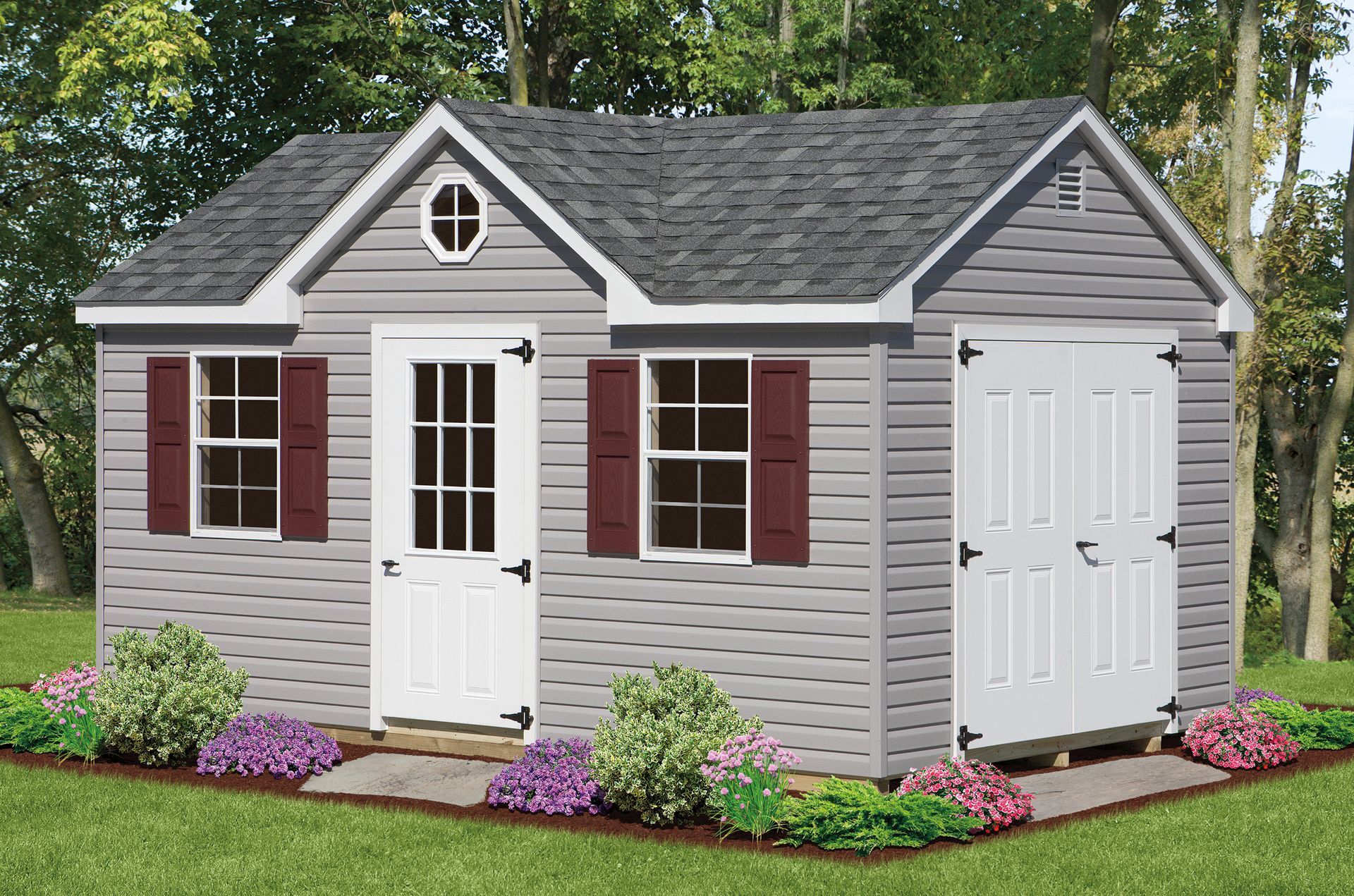 Gray shed with white doors and window trim, brown shutters, and landscaping.