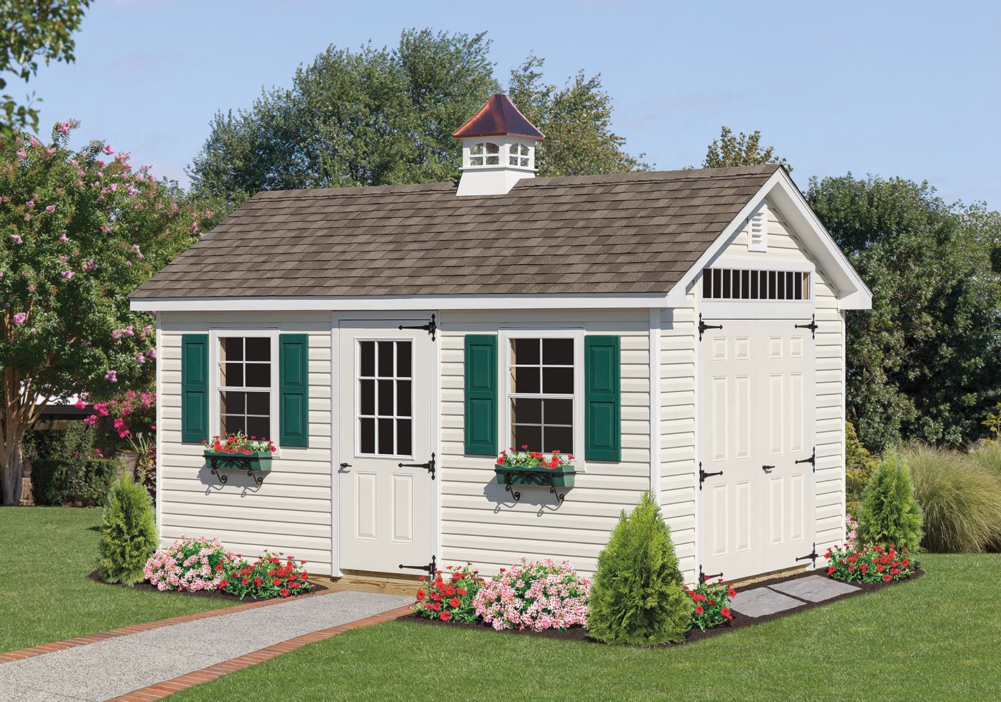 White shed with green shutters, flower boxes, and a pathway in a yard.
