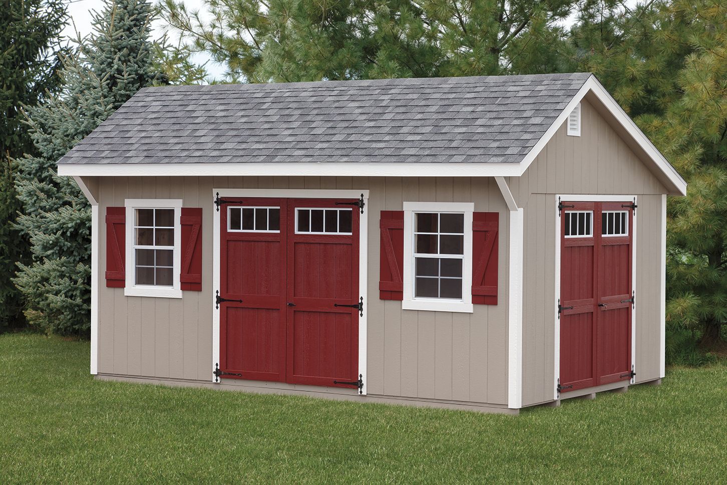 Tan shed with red doors and shutters, grey roof, on a green lawn.