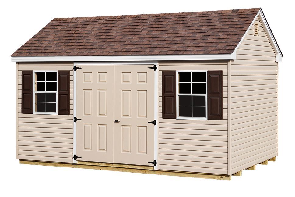 Tan shed with brown roof, two windows with shutters, and double doors on a wooden base.