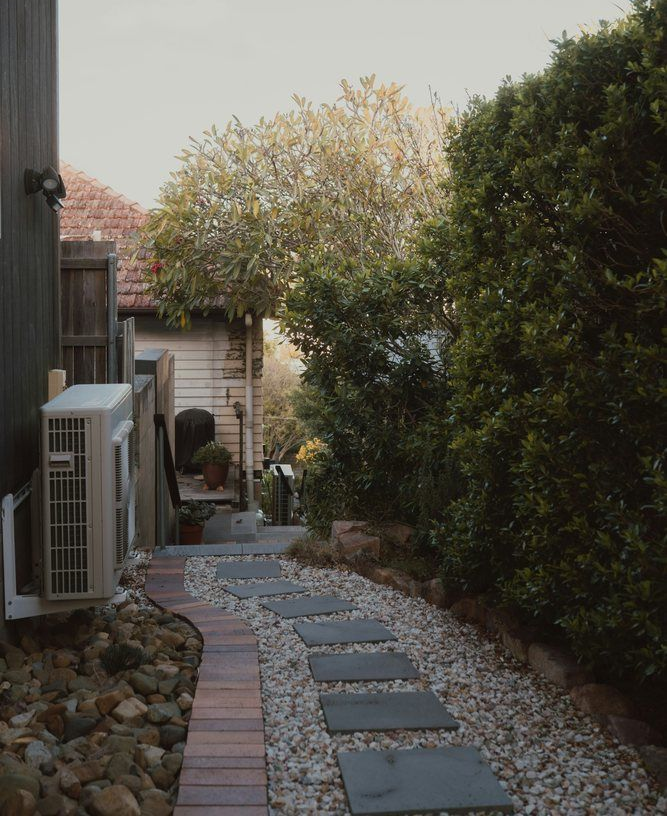 Side-yard path and landscaping considered during drainage planning in Jonesboro