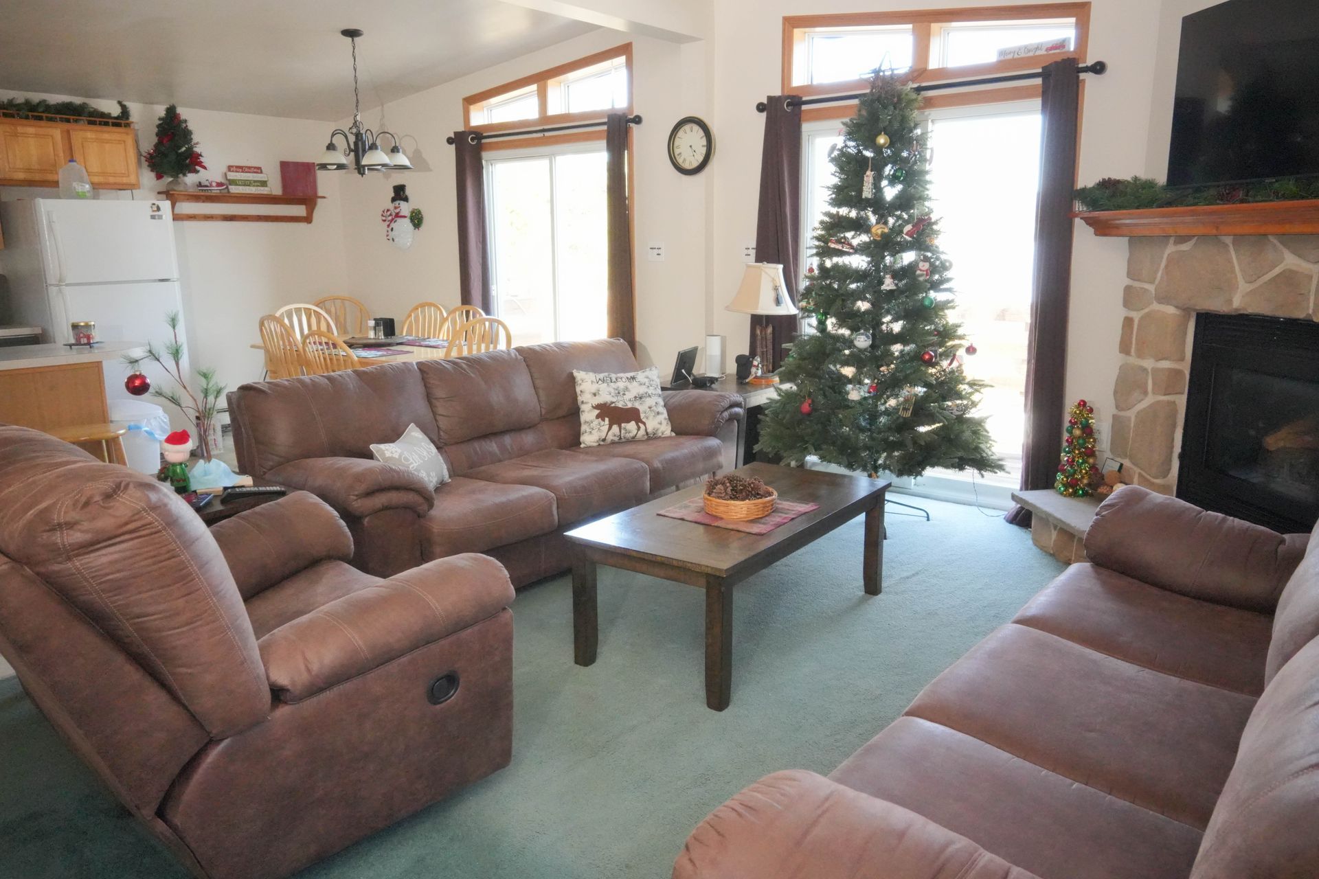 A living room filled with furniture and a christmas tree