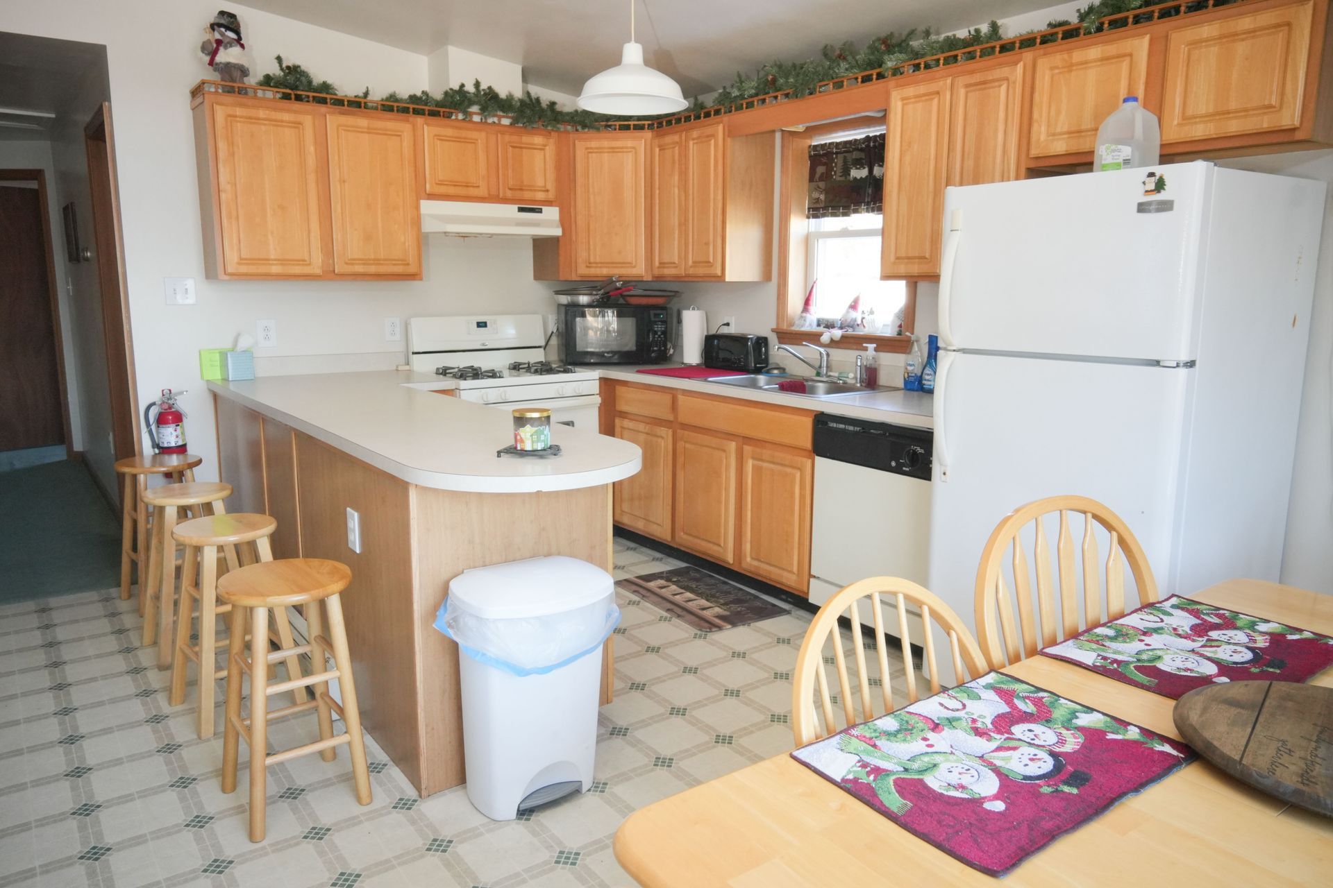 A kitchen with wooden cabinets and a white refrigerator