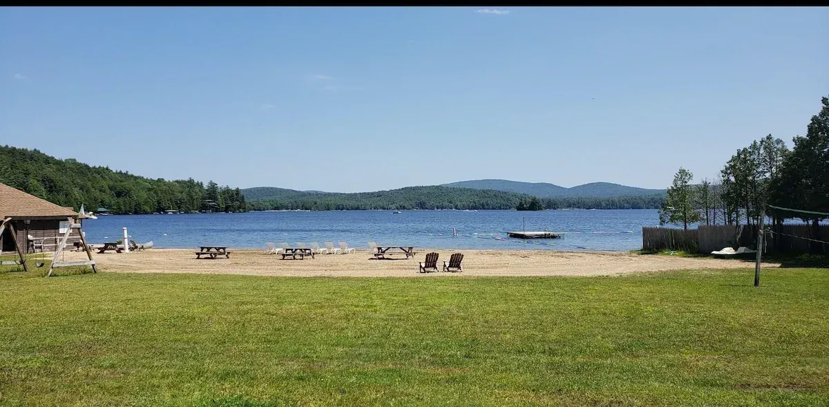 A view of a lake from a grassy field.