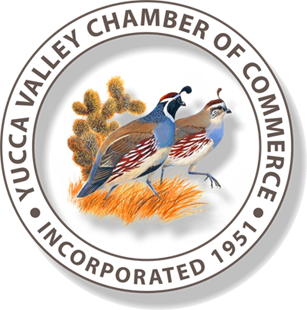 Yucca Valley Chamber of Commerce logo: Two quail with brown, white, and blue markings stand in front of a cactus, with the te