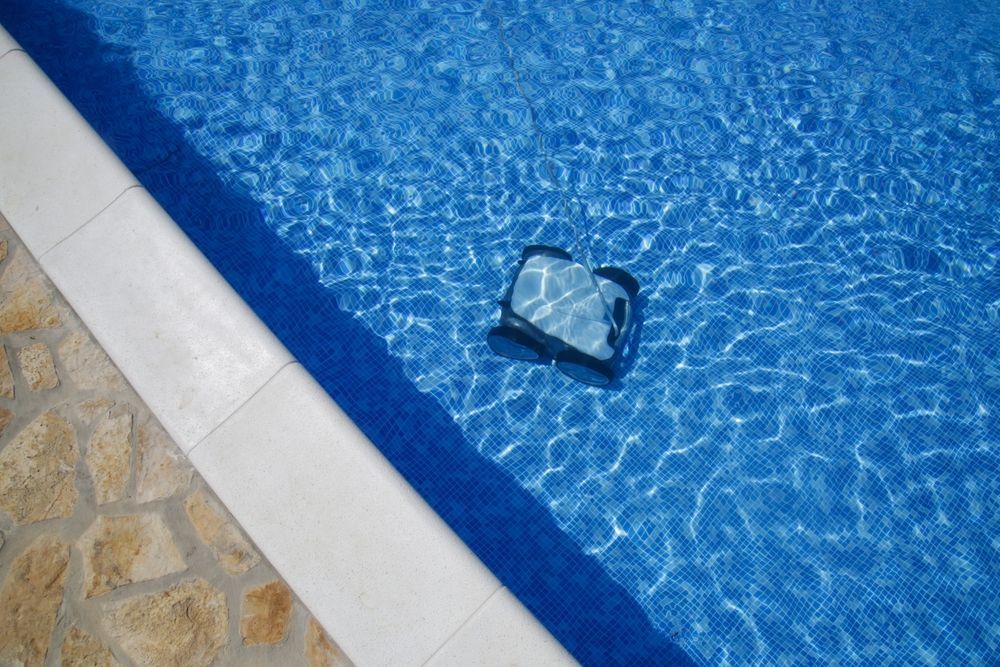 Robot Pool Cleaner in A Blue Tiled Pool — Ultra Clear Pool Care in Cranbrook, QLD