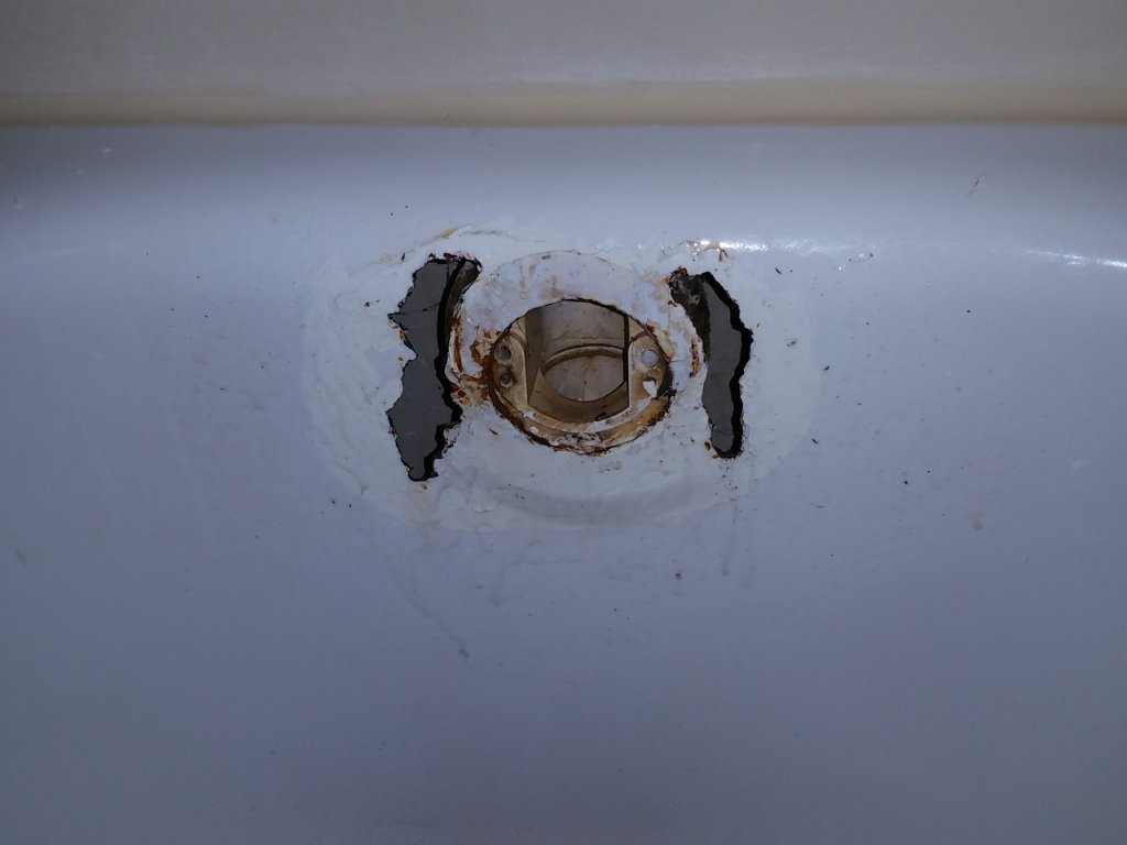 A close up of a sink with a hole in it