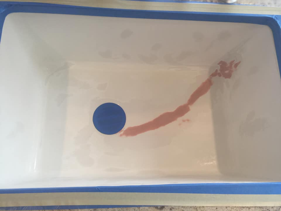 A white container with a blue circle in the middle of it.