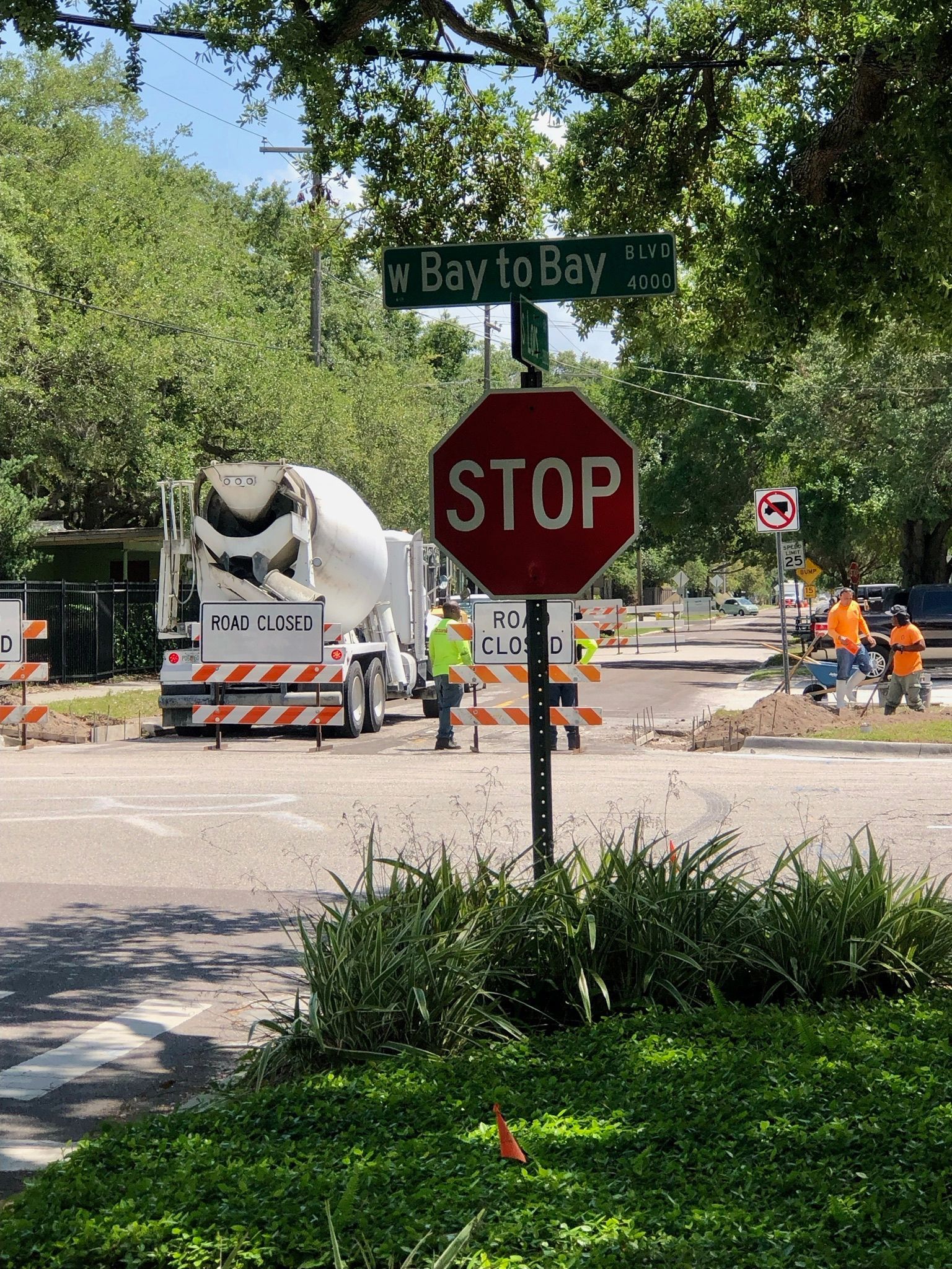 Roadwork at Bay to Bay intersection with stop sign and cement mixer truck.