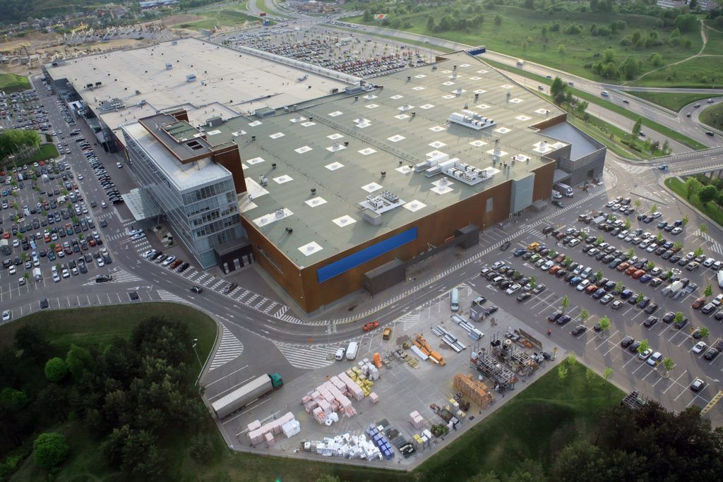 Large commercial building with extensive parking, aerial view.