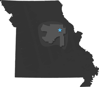 Dark gray outline map of Missouri with a blue star marker near the center.