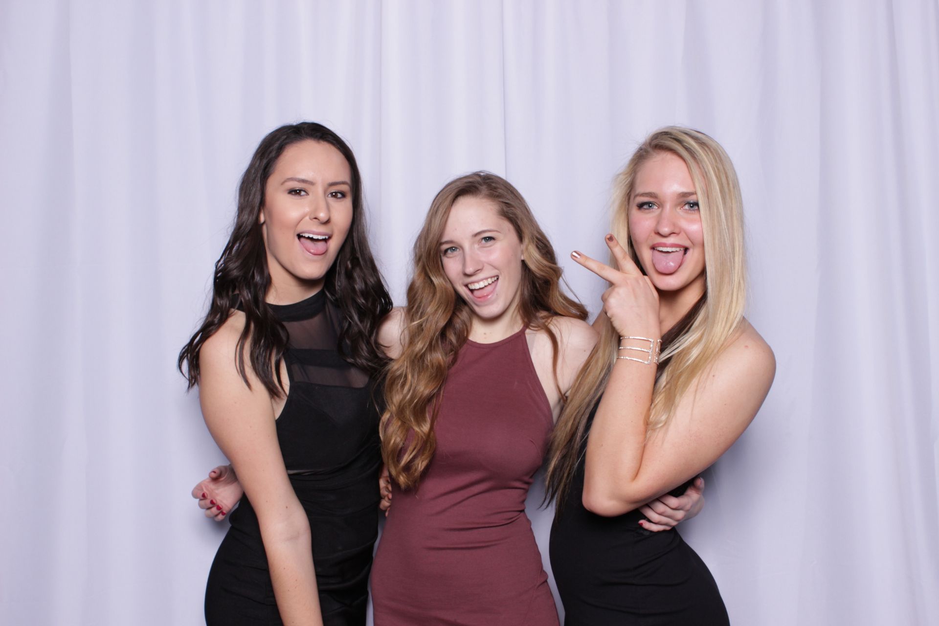 three women are posing for a picture in the Ever After photo booth at a bridal shower