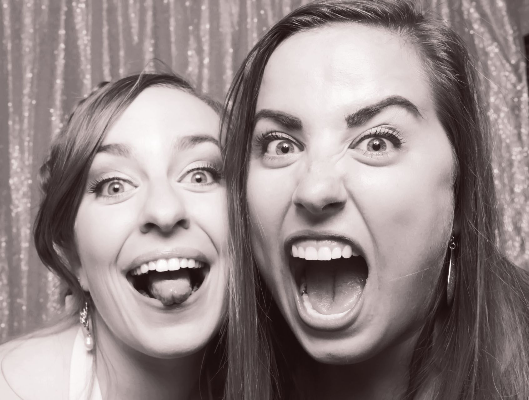 Close up of two Glam Photo Booth photo takers