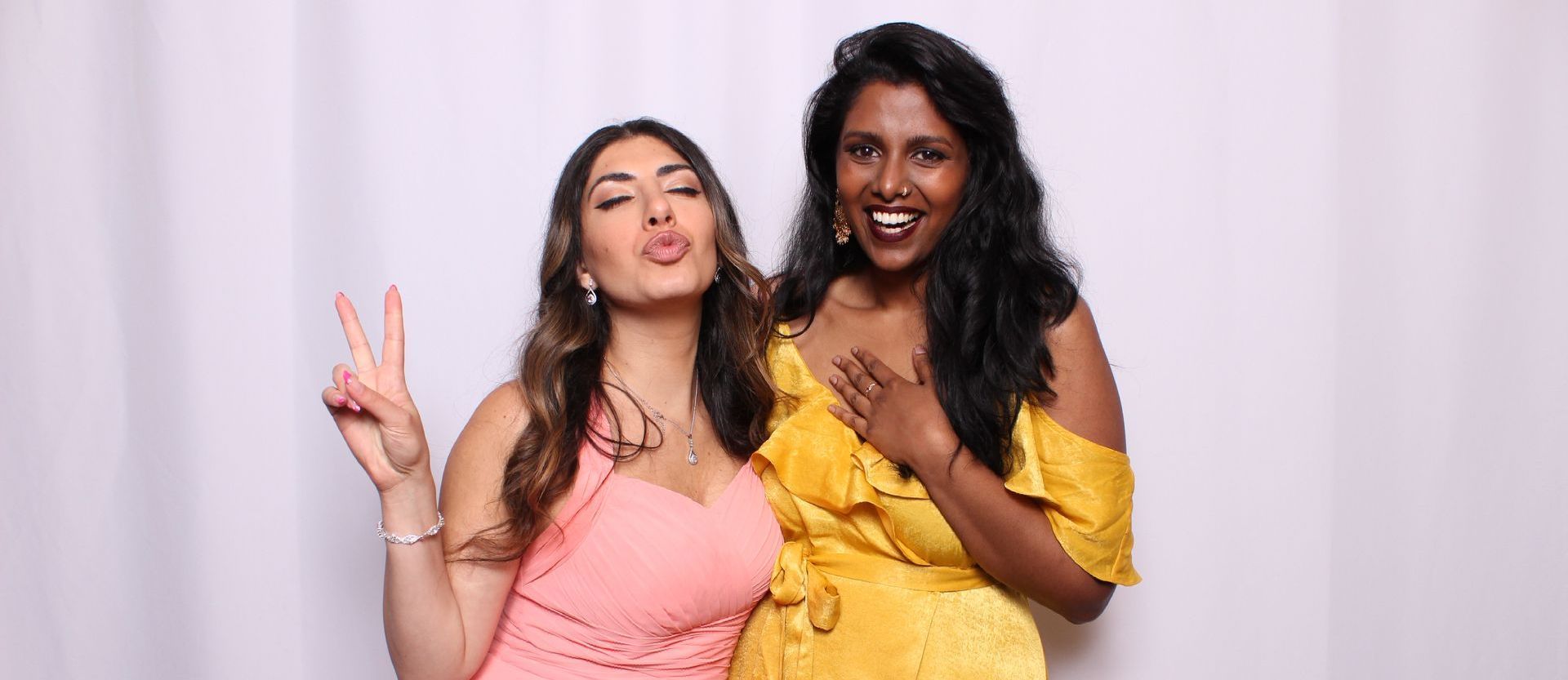 Two women coming together for an epic photo at the Ever After photo booth