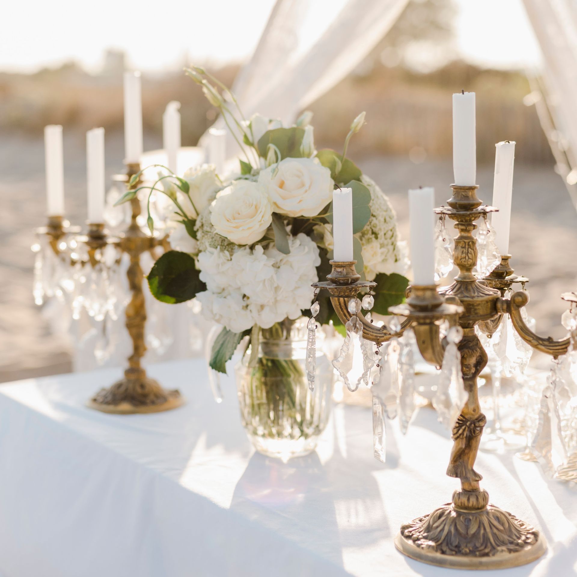A table with candles and flowers on it
