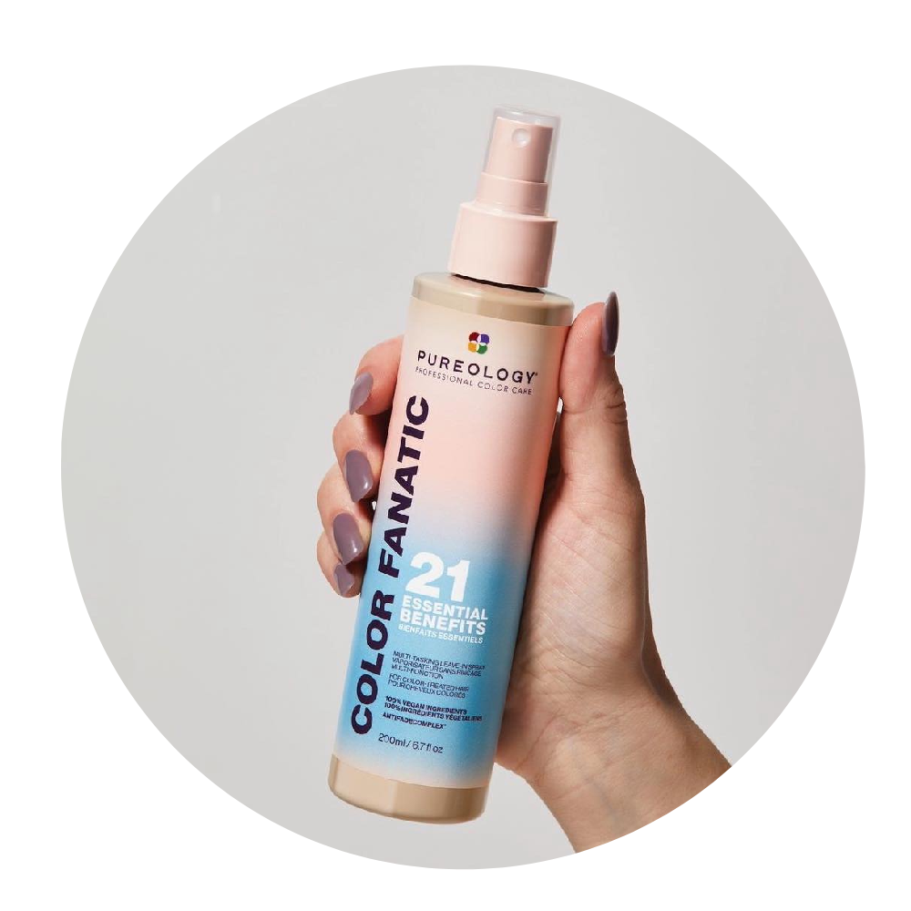 A person is holding a bottle of color fanatic 21 essential spray.