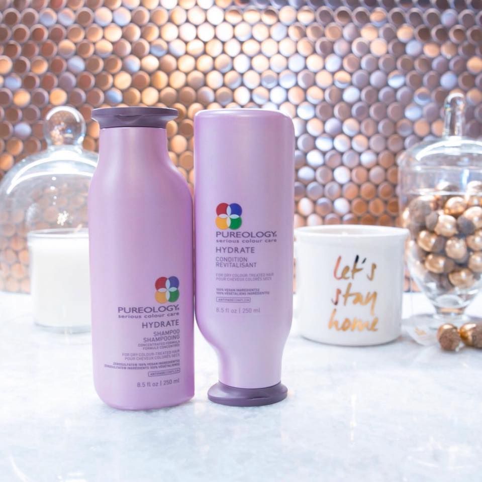 A bottle of pureology hydrate shampoo and conditioner