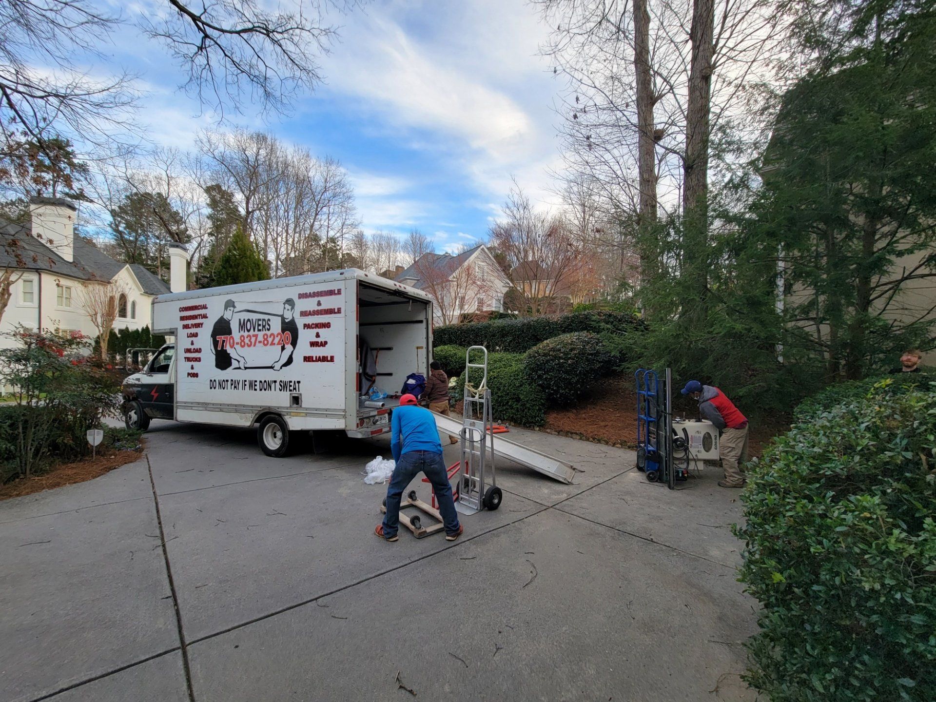 A man is carrying a large piece of furniture into a moving truck.