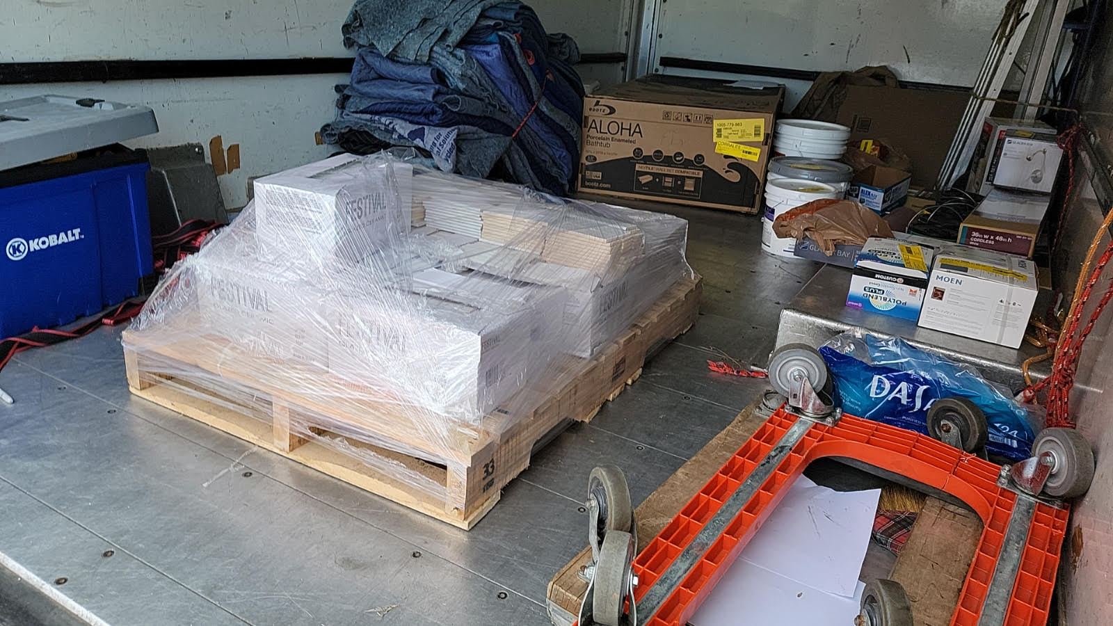 A wooden pallet is sitting on top of a metal table.