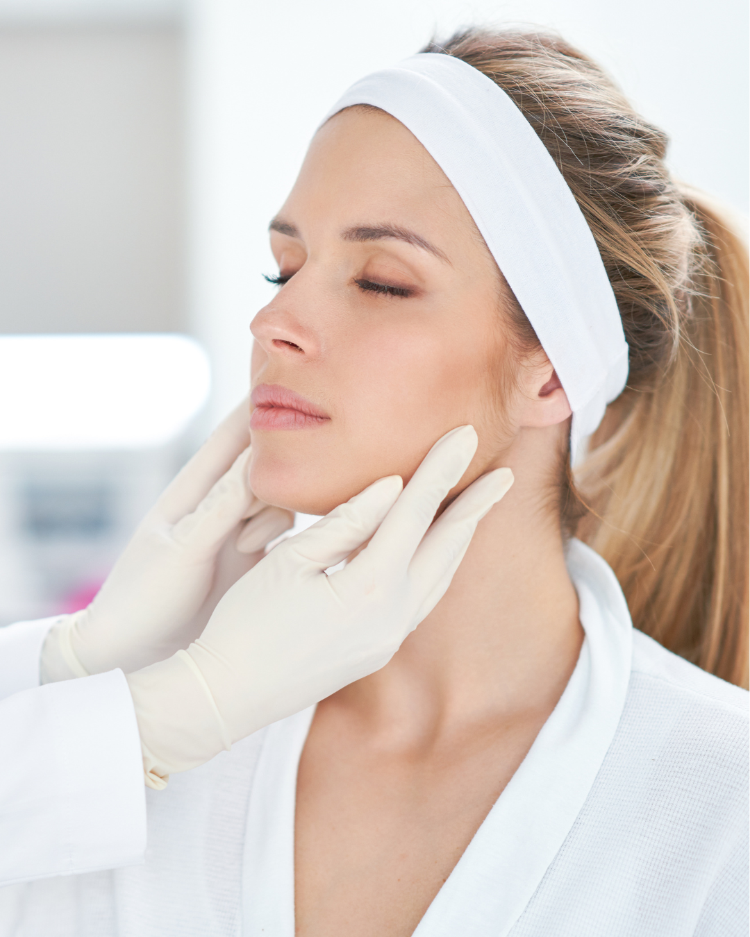 A professional in gloves examines a client's jawline during a skin treatment — Skin Haven Aesthetics Whitsundays in Airlie Beach, QLD