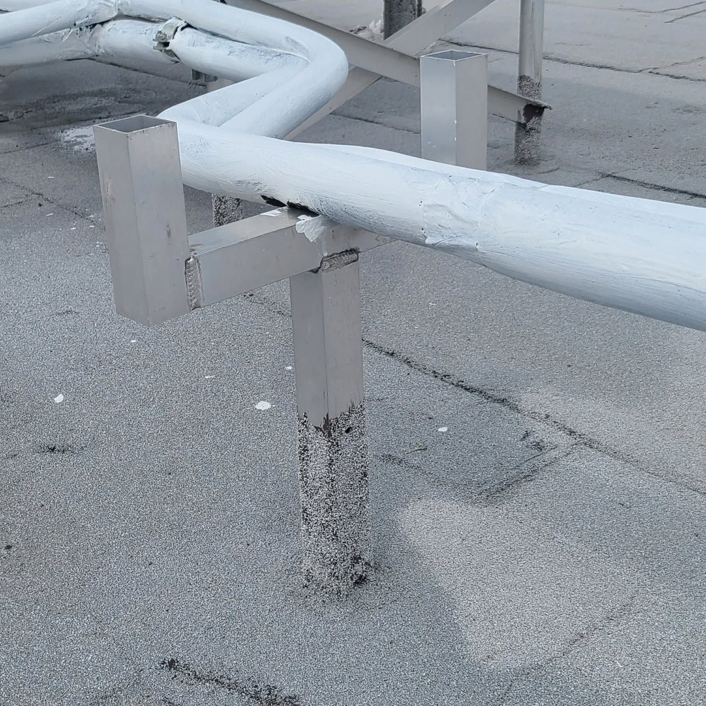 A white pipe is sitting on a concrete surface