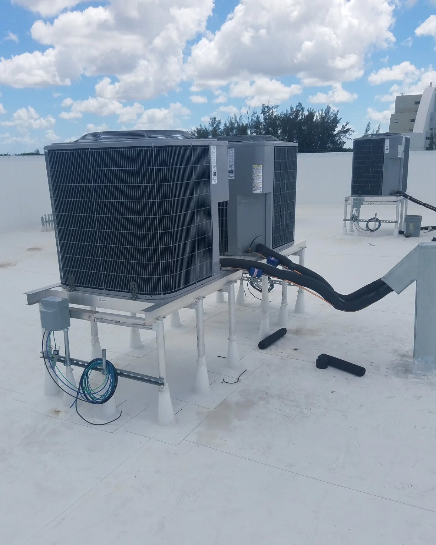 A roof with a lot of air conditioners on it