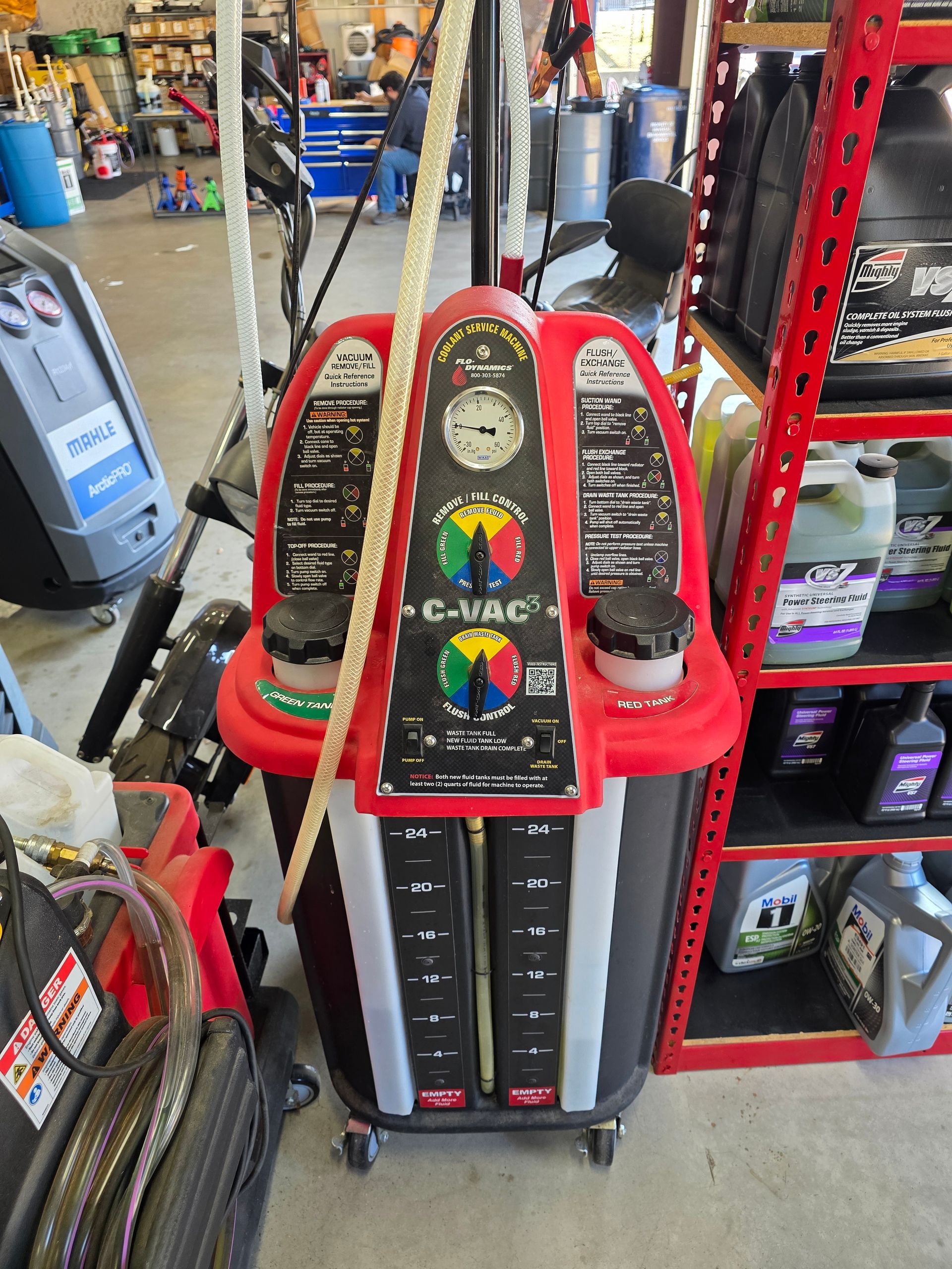Vacuum coolant exchange machine removing old acidic fluid at Quicker Sticker in College Station