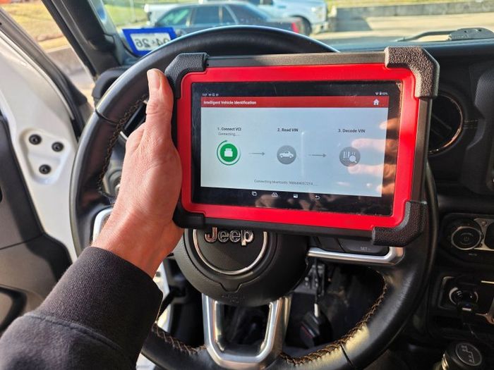 Mechanic diagnosing vehicle with Launch Professional Diagnostic Scan Tool in College Station