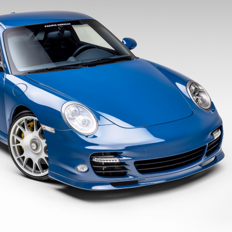 Blue sports car on a white background, front three-quarter view | Pacific Germany