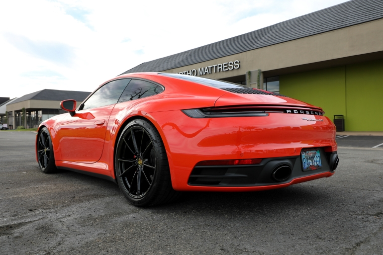 Red sports car parked outside a building on a cloudy daySilver and neon yellow sports car with oversized rear wing parked beside a white wall. | Pacific German