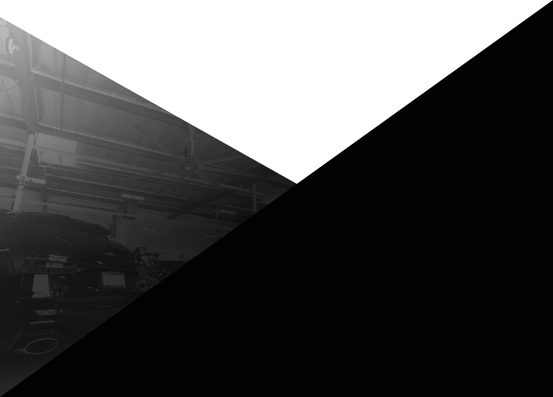 Abstract black-and-white geometric triangle composition with a faint industrial background on the left | Pacific German