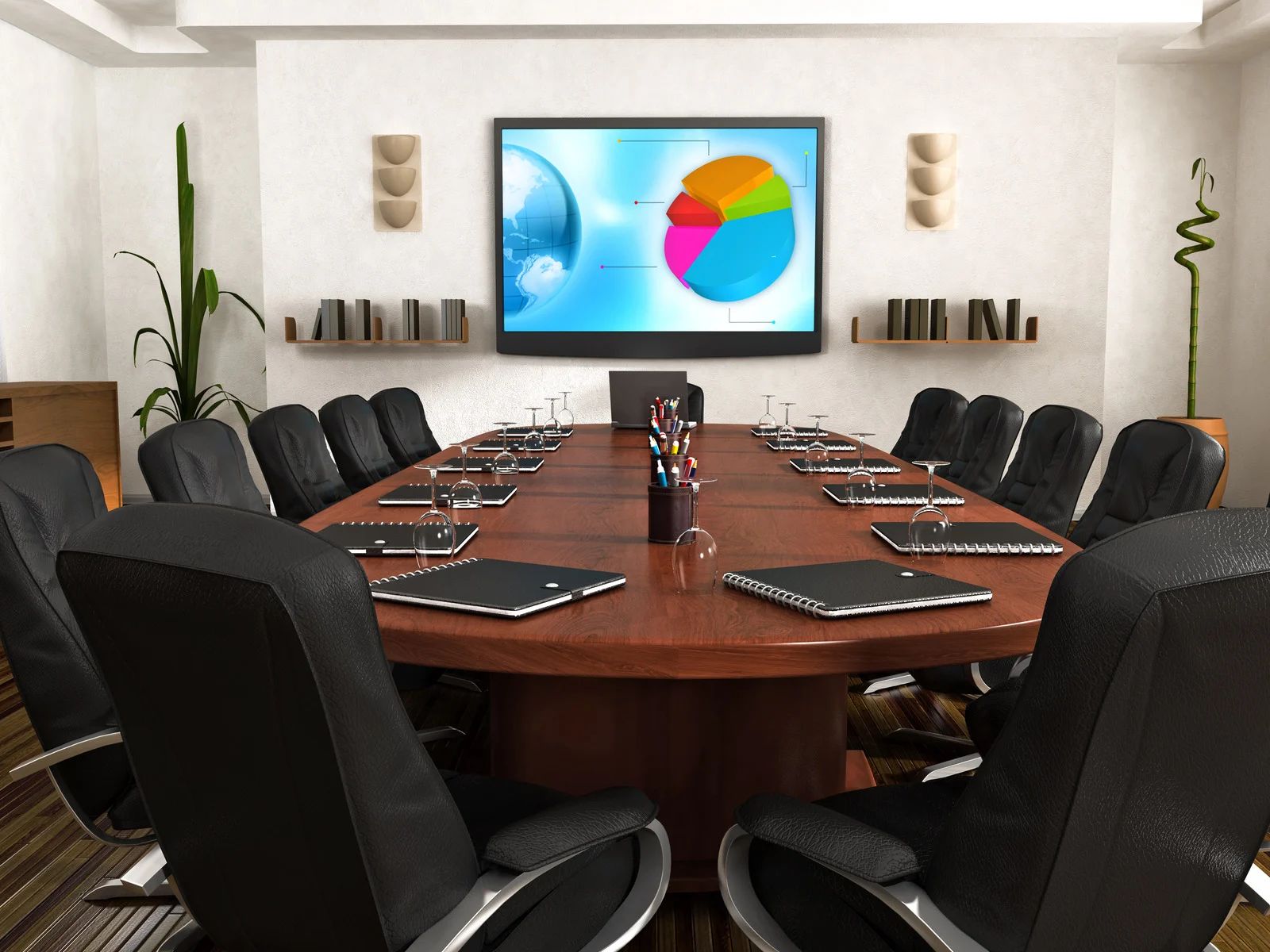 Modern conference room with oval table, black chairs, and wall-mounted screen showing colorful pie charts