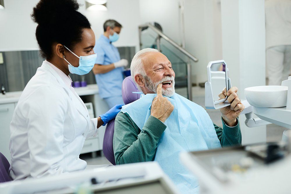 Old Man Checking His Teeth — Tonganoxie, KS — Tonganoxie Dental