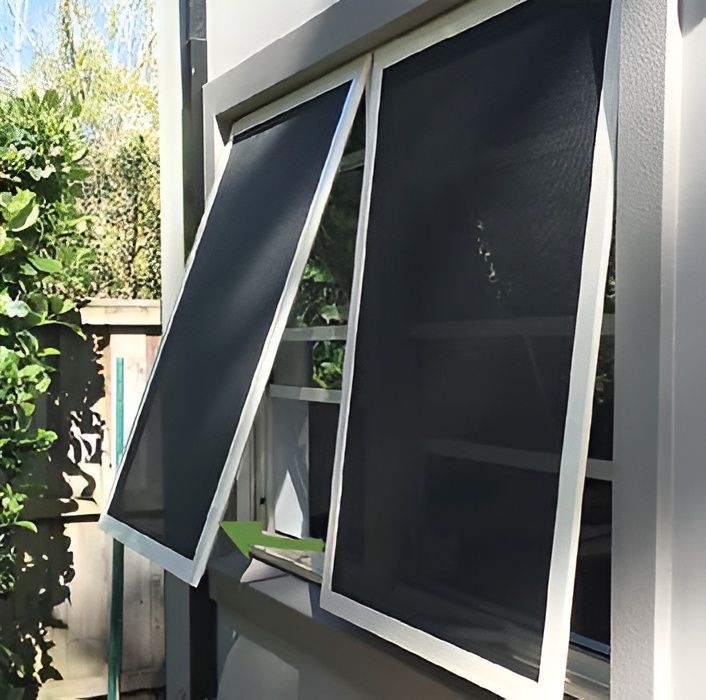 Two open windows with black screens and white frames against a white building exterior. — Maryborough Bay Glass & Aluminium in Howard, QLD