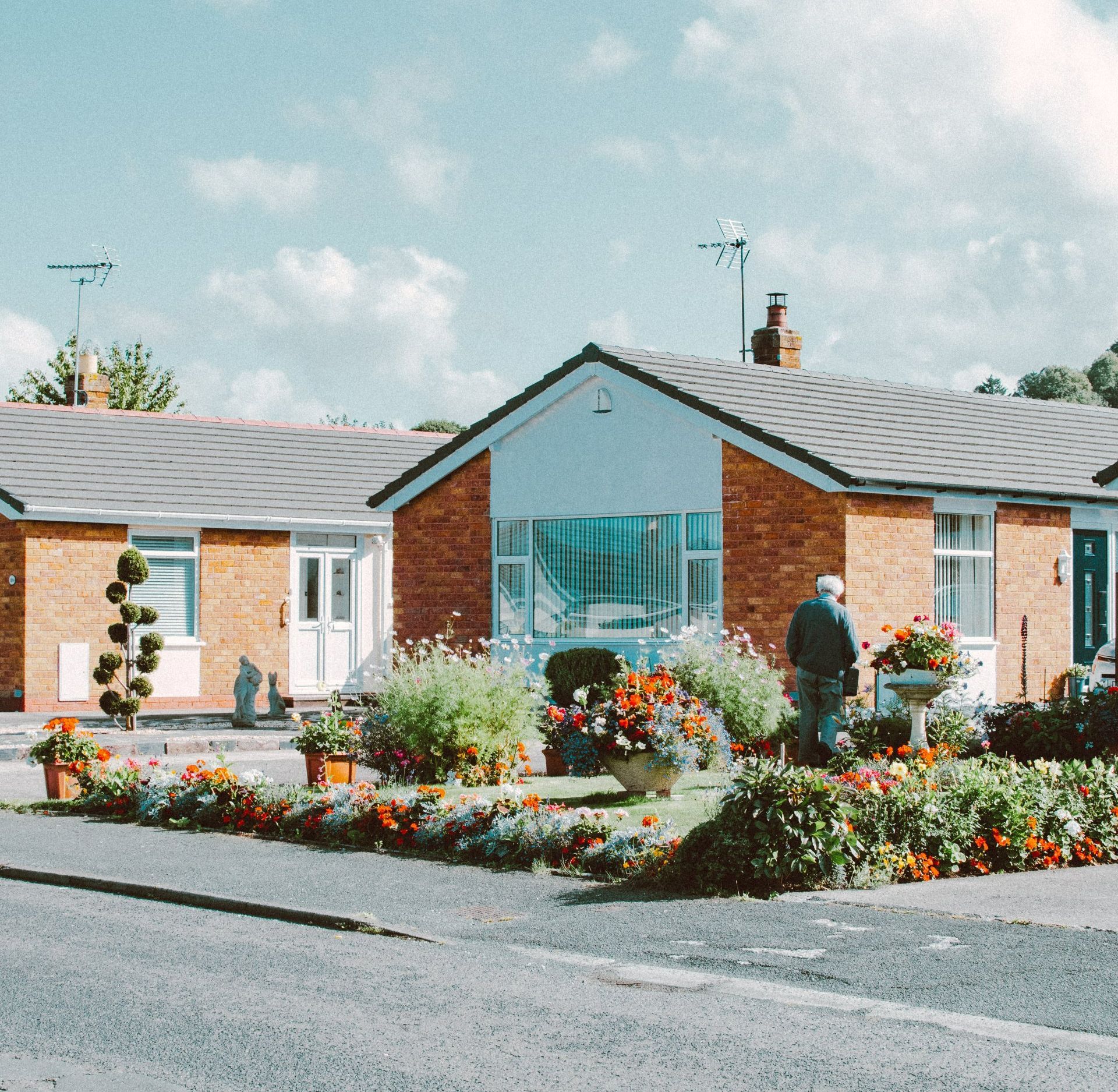 a person walking in front of a brick house