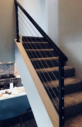 modern black metal railing featuring horizontal cable wires