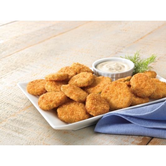A plate of chicken nuggets next to a bowl of dipping sauce
