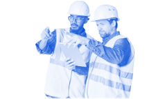 Two construction workers in hard hats reviewing plans on a clipboard